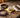Skidmore's Leather Cream, a buckstitch belt, and split reins on a workbench