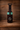 Dark brown leather saddle water bottle holder with turquoise suede top, rear billet mount"