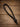 Full length view of a black braided nylon rope tie down keeper loop with knotted end