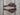 Pair of chocolate Hermann Oak harness leather cowboy spur straps with black steel scroll buckles on weathered barnwood
