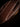 Close-up of white saddle stitching and burnished edge on a dark leather fixed blade knife sheath