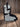 Black and white hair-on-hide cowhide boot bag standing on weathered barnwood, side profile