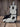 Side of black and white cowhide boot bag showing large black spots and zippered pocket