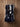 Top view of black and white cowhide boot bag showing two zippered boot compartments