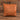 Tan leatherette 15 inch throw pillow with a laser engraved show lamb silhouette on the front, set on weathered barnwood
