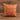 Tan leatherette 15 inch throw pillow with a laser engraved show steer silhouette on the front, set on weathered barnwood