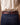Back view of the purple buckstitch belt showing double-row purple lacing on brown leather