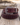 Purple Heritage Buckstitch Belt coiled on weathered barnwood with lasso rope, dark brown leather with purple buckstitching and engraved silver western buckle