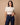 Model wearing the Purple Heritage Buckstitch Belt with dark jeans, studio product photo