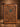 Western tooled leather portfolio with floral tooling and turquoise concho on the front, zipper closure, standing on a wood table
